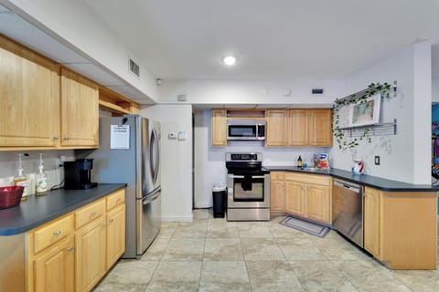 Spacious kitchen with warm wooden cabinetry.

