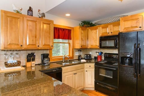 Kitchen is outfitted w/ an electric Range & assortment of small appliances