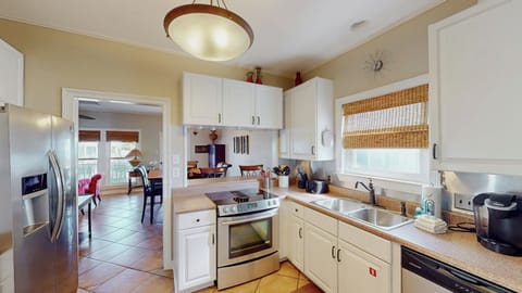 The bar between the kitchen and dining area provides a cozy space for loved ones to join you in conversation while you prepare delicious food to enjoy together.