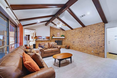 Living Room: Spacious retreat with wooden beams, plush seating, and a warm fireplace ambiance!