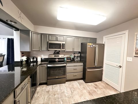 A sleek and modern kitchen with stainless steel appliances, perfect for preparing meals.