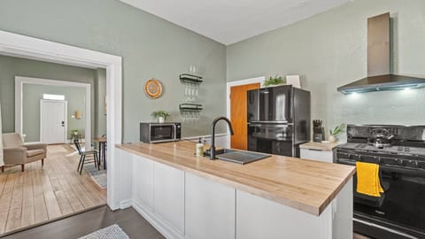 Fully equipped kitchen just off the side of a dining room. 
