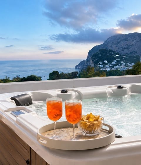 Private outdoor jacuzzi on the terrace, with open sea views — the perfect spot for sunset aperitivo.
