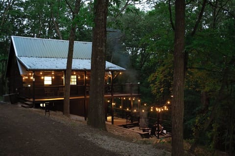 Spend evenings around the crackling fire pit, then relax on the covered deck—all while soaking in serene woodland views.