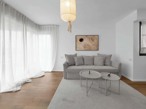 Sink into the soft sofa, sunlight pouring through sheer curtains - your slow marina mornings start right here.