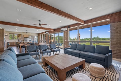 The Great Room. Open concept lounge, dining, & kitchen, w/cozy fireplace.