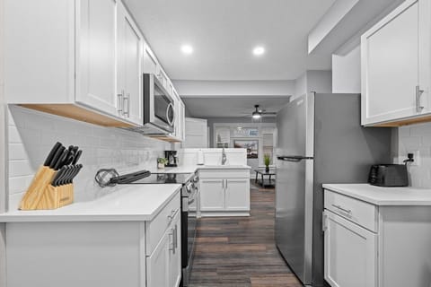 Bright and functional kitchen area, with a stylish tiled backsplash and all essentials