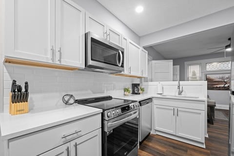 Modern kitchen with sleek countertops, perfect for preparing meals at home