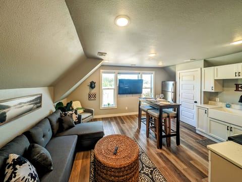Upstairs 1BR, 1BA apartment with smart TV, couch, pub table, and full kitchen.