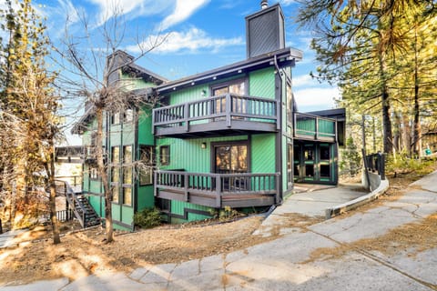 Welcoming front view with charming architecture, inviting guests to step into a cozy retreat surrounded by natural beauty