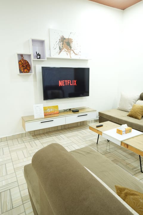 Modern entertainment options with an elegant Smart TV and seating area.