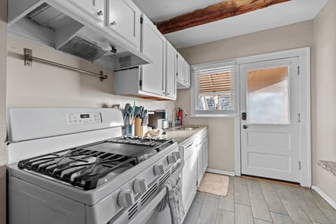 The airy kitchen offers ample space & every home comfort