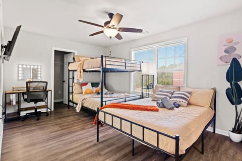 This cozy bedroom features a fun bunk bed and a comfy double bed.