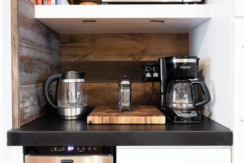Start your morning at this charming coffee station, complete with a French press, electric kettle, and drip brewer.