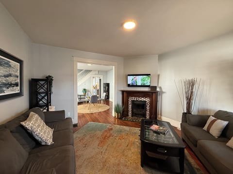 Living room with historic fireplace (decorative only, sorry!) and TV