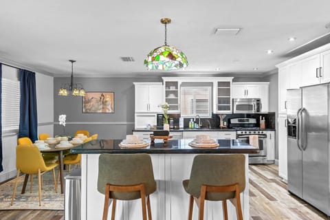 Kitchen with bar seating for 2 and the dining area is at the left
