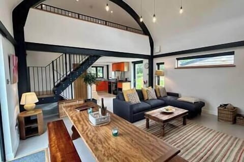 Double height living area with double sofa bed and large dinging table (1)