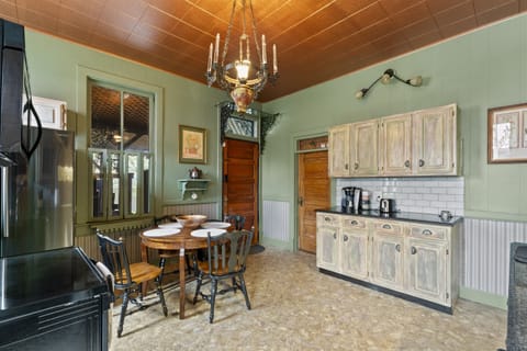 Enjoy casual meals or morning coffee at the kitchen table, featuring comfortable seating and a stylish setup.