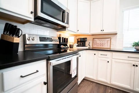 The fully stocked kitchen is equipped with brand-new cookware, dishes, and all the tools you need to whip up meals or game-day snacks.