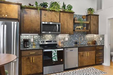 Fully equipped kitchen with all your cooking essentials, drip coffee maker + coffee. Dining table with seating for 2. This room opens up into the living room. Lush, vibrant decor throughout the entire condo!