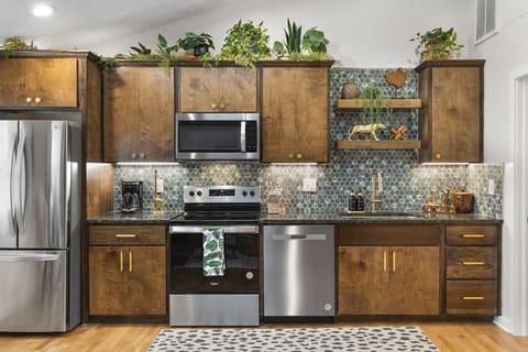Fully equipped kitchen with all your cooking essentials, drip coffee maker + coffee. Dining table with seating for 2. This room opens up into the living room. Lush, vibrant decor throughout the entire condo!