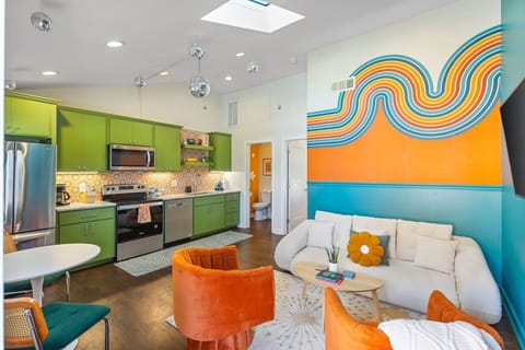 Bright living room with lots of natural light! Smart TV with all the apps you could want. The couch turns into a futon sofa. Unique murals and decor throughout the entire condo!