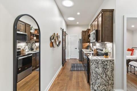Fully equipped kitchen with all your cooking essentials, drip coffee maker + coffee. Dining table with seating for 6. This room opens up into the living room. Unique colors, wallpaper and decor all throughout the condo.