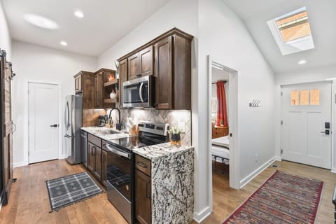 Fully equipped kitchen with all your cooking essentials, drip coffee maker + coffee. Dining table with seating for 6. This room opens up into the living room. Unique colors, wallpaper and decor all throughout the condo.