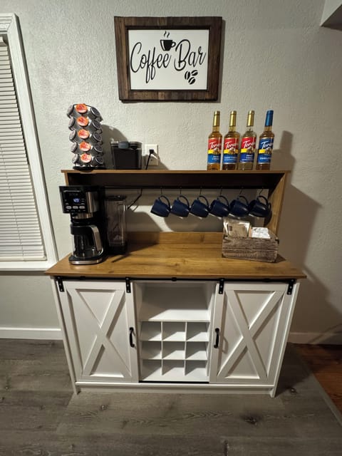 MAIN LEVEL, KITCHEN:  Open floor concept flows from Living Room into the Kitchen with  Deluxe Coffee Bar: Deluxe Dual Ninja Coffee maker with both single serve, K-cup coffee pods, or  make a pot  of your favorite grind, Special variety of coffee syrups,  Manual Coffee Grinder,  and a French Press for all the coffee connoisseurs.  Selected variety of organic tea bags.
