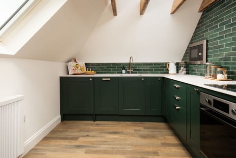 The Hayloft, Kailzie - first floor kitchen with electric oven and hob, dishwasher, microwave and undercounter fridge