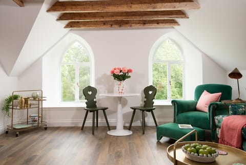The Hayloft, Kailzie - bright and airy seating and dining area featuring pretty arched windows and exposed beams