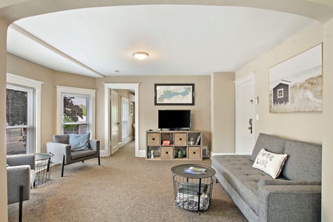 Main living area with seating, couch, and smart TV