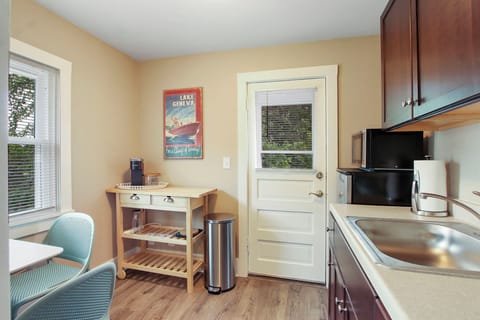 Kitchenette set-up (no stove) opening up to shared balcony