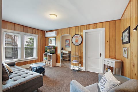 Main living area with seating, sofa, and smart TV