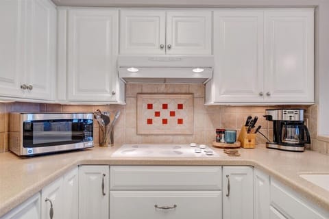 Kitchen is fully stocked to cook at home, all while enjoying the view of the lake.