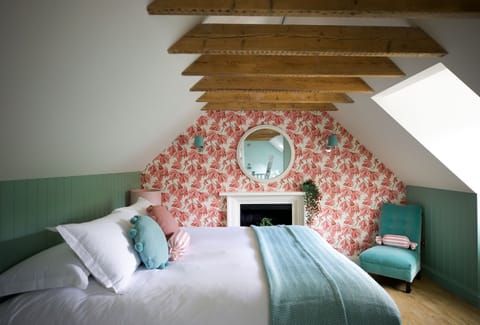 Stables Cottage - the bedroom beneath the beams on the first floor with a super king size bed