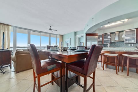 Enjoy meals with a view in this beautifully integrated dining and kitchen space. The expansive windows and open concept design create a light-filled and airy atmosphere.