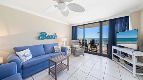 Coastal Comfort. Bright and breezy living room with direct balcony access and incredible Gulf views—perfect for relaxing with a movie or watching the waves.