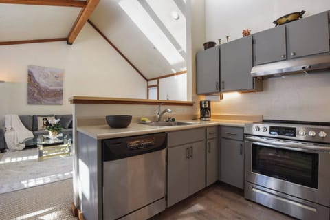 Kitchen with drip coffee pot, dishwasher, slow cooker and electric stovetop