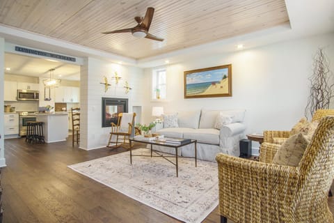 Living Room - Spacious and Brightly lit Living Room with mounted Smart TV and Gas Fireplace. View from the Entryway.