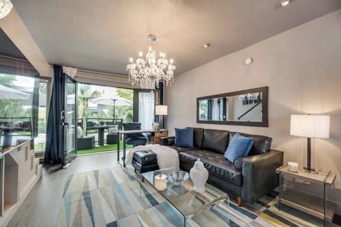 Spacious, open-concept living area that's bright and airy, offering plenty of room to relax on the leather sectional and unwind.