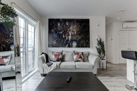 A bright and airy living space with a comfy sofa, stylish decor, and a great view. 🌿🛋️