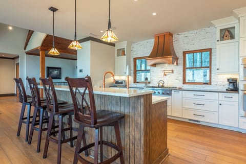 Craft delicious meals in the spacious chef's kitchen with bar seating for 4, gas range, dishwasher, and standard drip-stye coffeemaker.