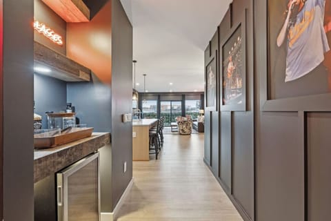 MW hallway with music-themed décor and a convenient bar nook—complete with a mini fridge and extra space for drinks, snacks, and pregame essentials.