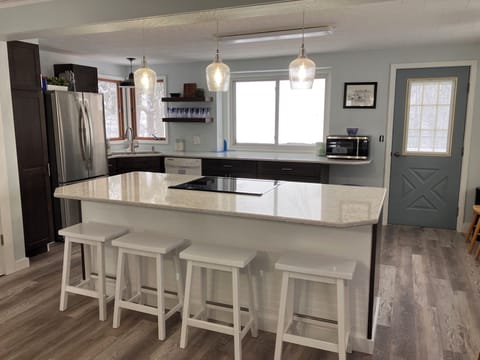 Kitchen - Kitchen with Island, Bar Seating and Door to the Deck Overlooking Oxbow Lake