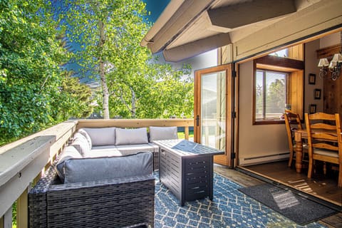 The dining room seamlessly opens to an inviting outdoor living space, ideal for open-air meals and relaxation.