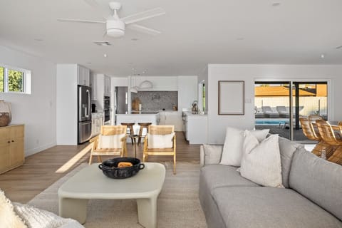 Seamless open-concept living and kitchen area with direct pool access.