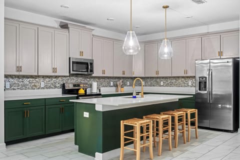Stylish kitchen with gold accents and modern lighting. ✨ #LuxuryKitchen