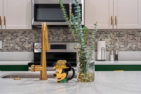 ✨ Chic kitchen with a golden faucet and Disney magic! #HomeDecor