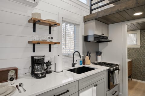 A compact kitchen with big functionality—cook your favorites in the fully stocked kitchen, enjoy your morning brew from the coffee bar, and savor it all just steps away in the cozy dining nook